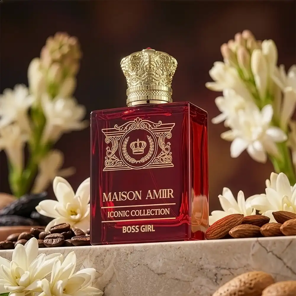 Maison Amir perfume bottle with decorative elements on a surface with flowers and almonds.
